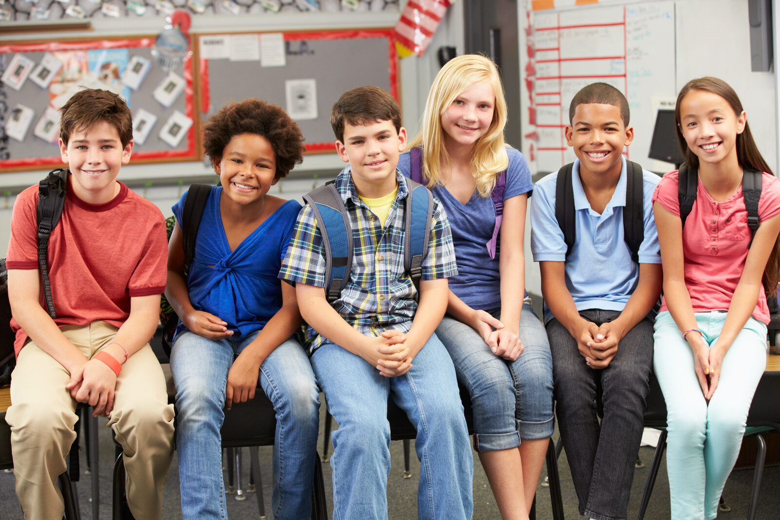A group of elementary school students with backpacks